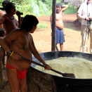The King is given a demonstration of how the Indians make flour from the root vegetable manioc.  (Photo: Rainforest Foundation Norway / ISA Brazil)